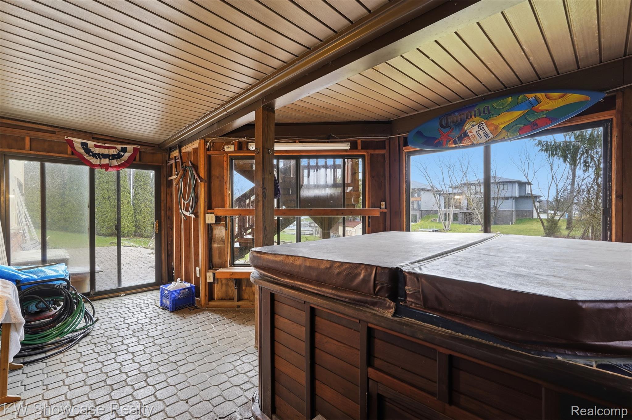 3330 Benstein Road Commerce Township, MI 48382 - Photo 21 of 40 Sunroom featuring a hot tub w/ doorwall to paver patio