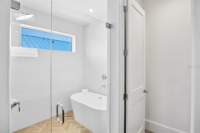 a bedroom with a balcony a bed and a chandelier