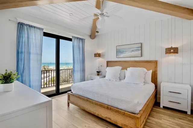 a spacious bedroom with a bed and a flat screen tv