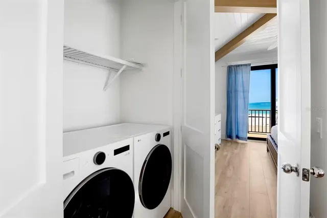 a roof deck with outdoor seating and wooden floor