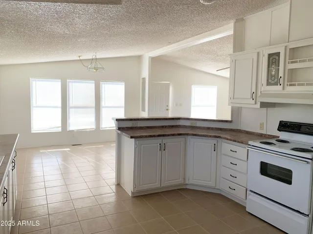 a kitchen with a sink a stove and cabinets