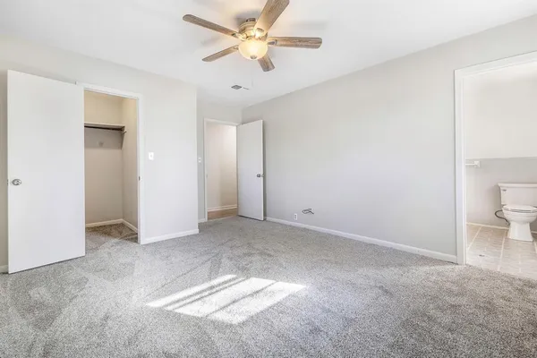 a view of a big room with a ceiling fan and a closet