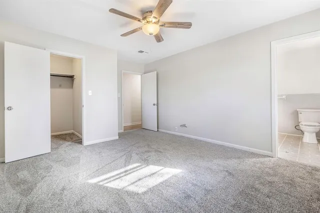 a view of a big room with a ceiling fan and a closet