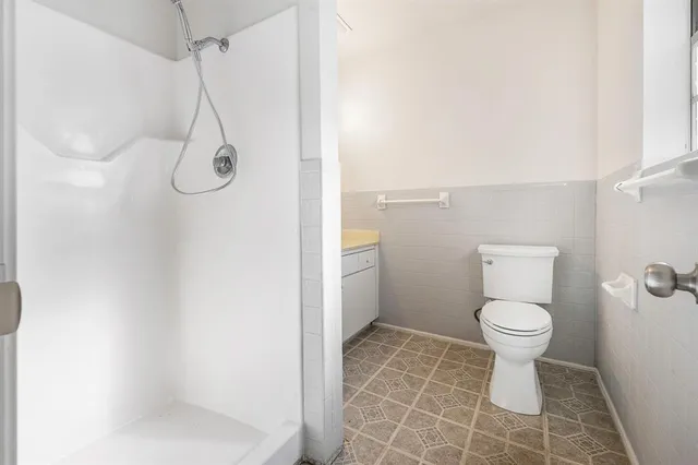 a bathroom with a toilet and a shower
