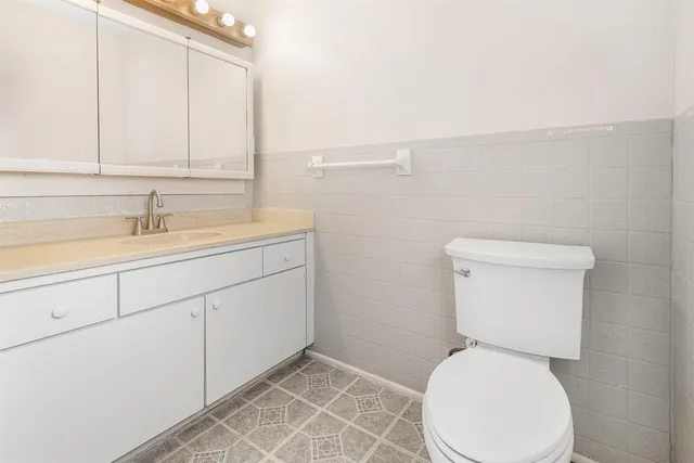 a white toilet sitting next to a bathroom sink