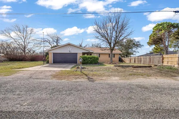 a view of a house with a yard and wooden fence