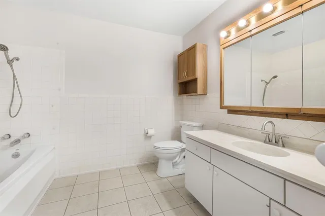 a bathroom with a sink a toilet and mirror