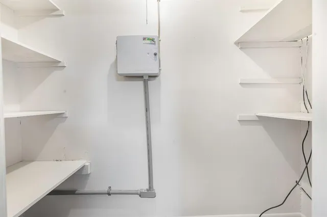 a room with a white wall and a table