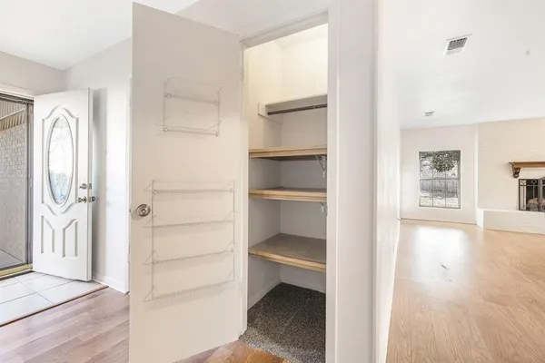 a view of walk in closet with empty racks