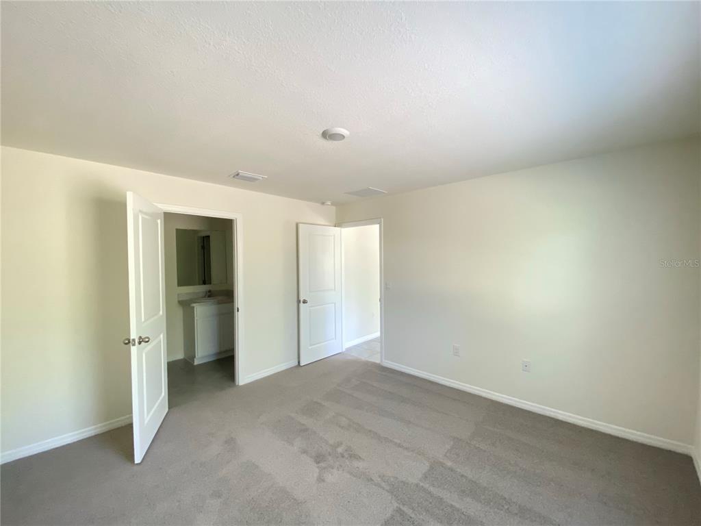 492 Hickory Course Loop Ocala, FL 34472 - Photo 23 of 28 an empty room with closet and a bathroom