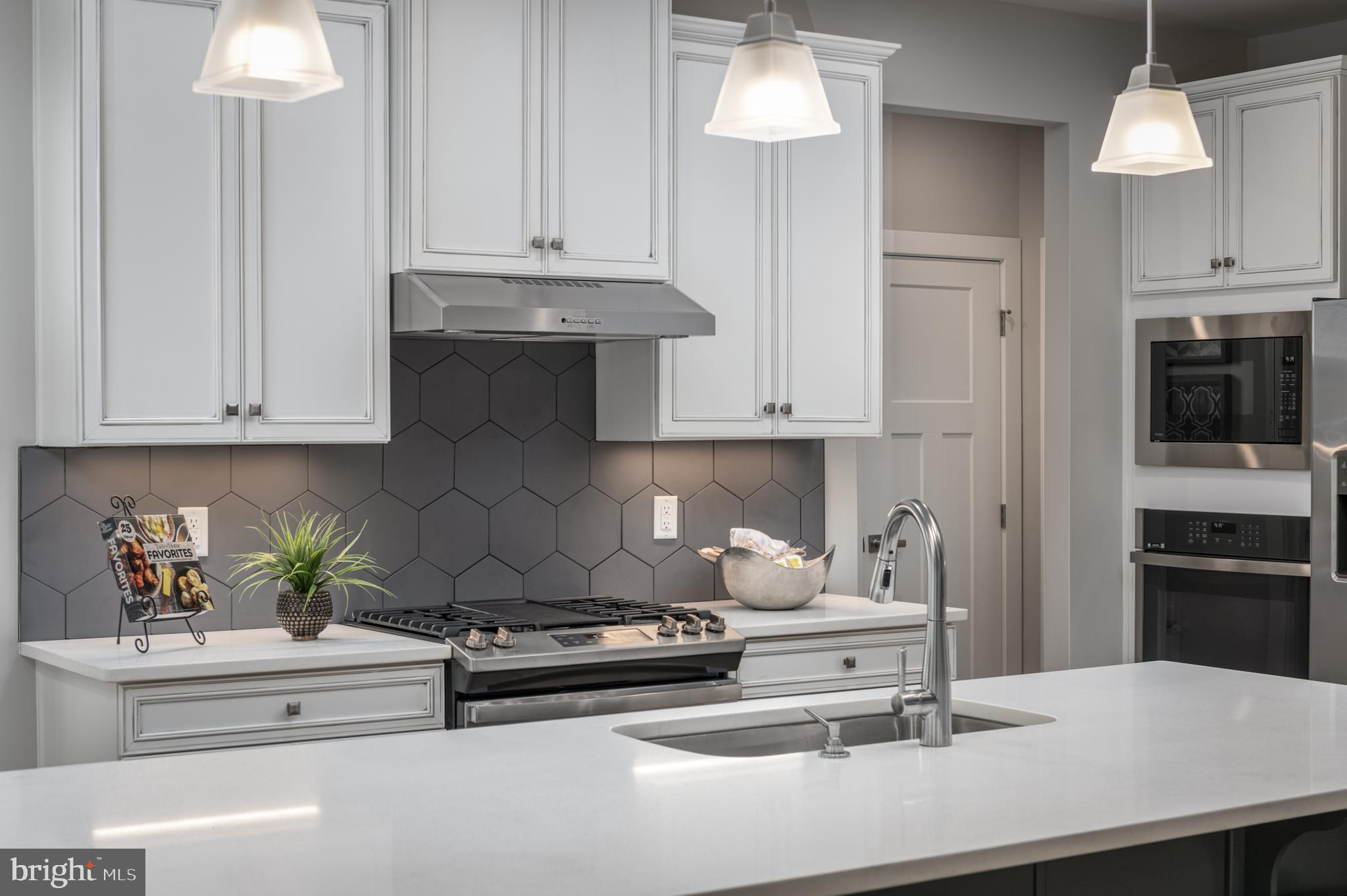 52 Wallace Way Ranson, WV 25438 - Photo 13 of 18 a kitchen with stainless steel appliances a white stove top oven and cabinets