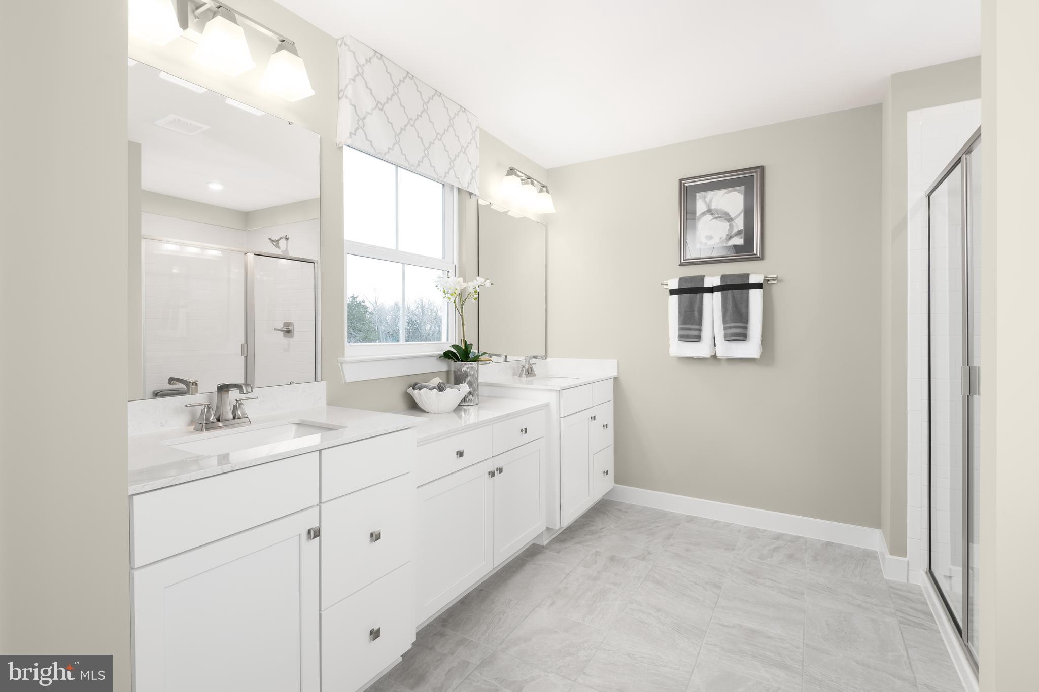 52 Wallace Way Ranson, WV 25438 - Photo 15 of 18 a bathroom with a double vanity sink a mirror and a bathtub