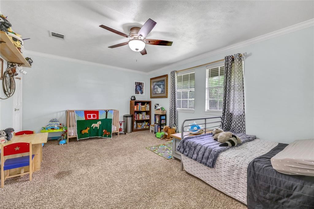 11350 Grant Road Cypress, TX 77429 - Photo 14 of 41 a bedroom with bed and window