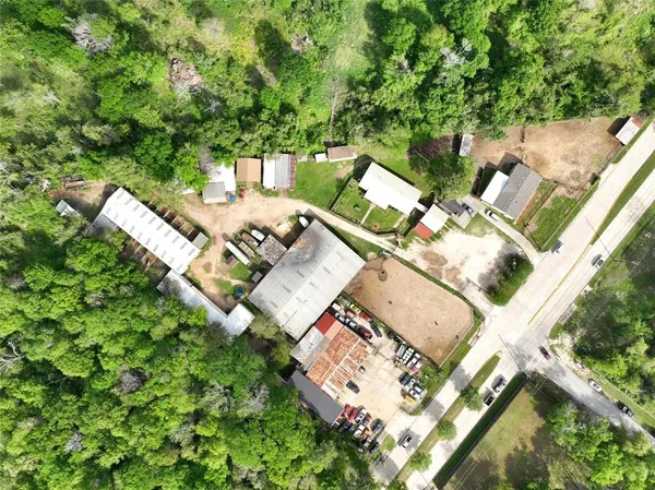 an aerial view of a house with a yard and garden