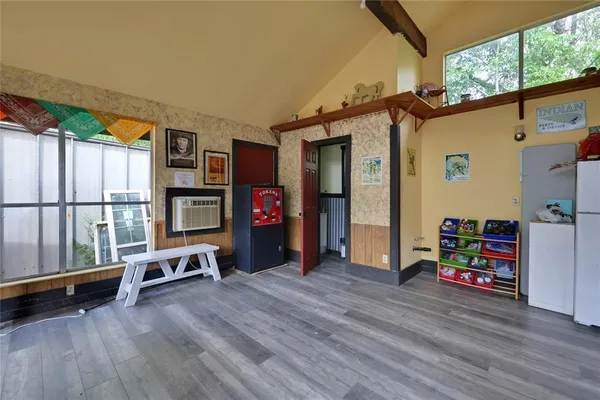 a view of a hallway with wooden floor and furniture