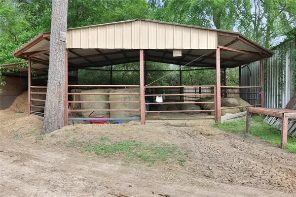 a view of a backyard with a small barn and a table and chairs