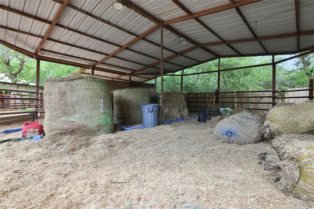 11350 Grant Road Cypress, TX 77429 - Photo 34 of 41 a backyard of a house with table and chairs under an umbrella