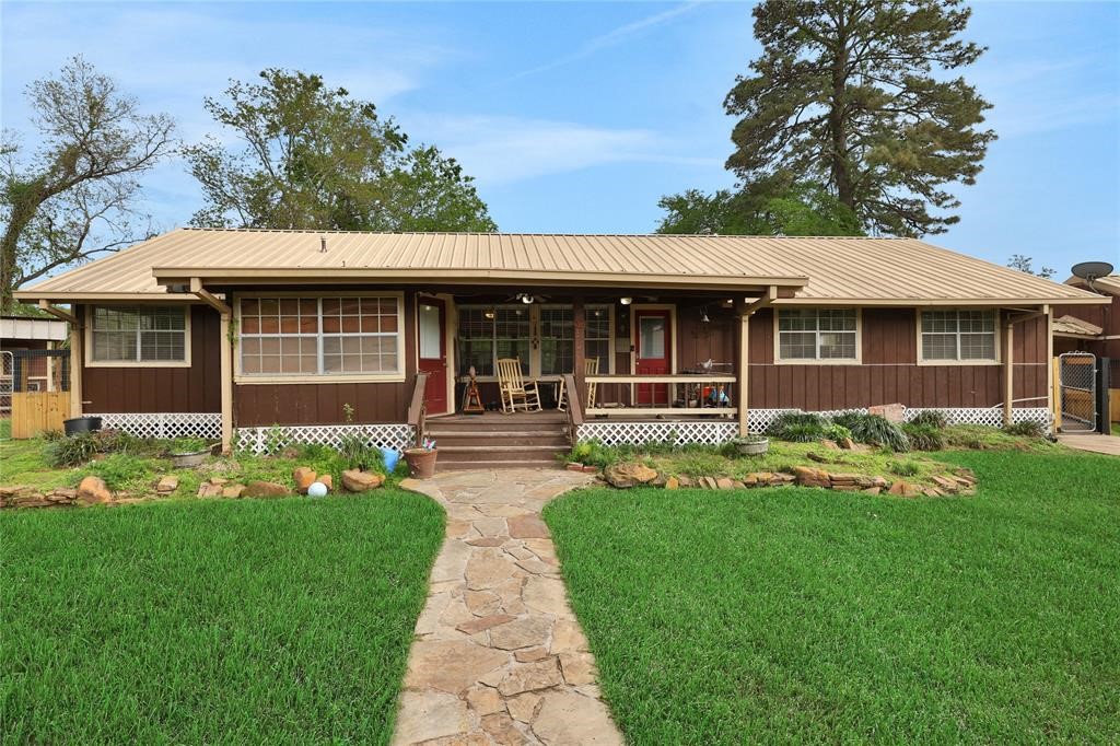 11350 Grant Road Cypress, TX 77429 - Photo 5 of 41 a front view of a house with a garden and trees