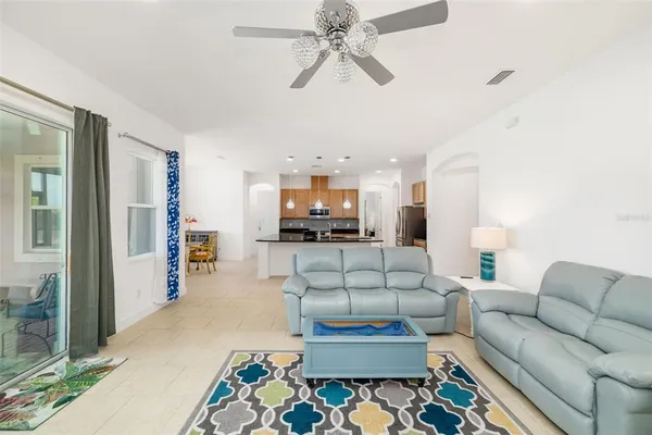 a living room with furniture and kitchen view