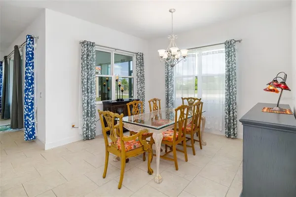 a view of a dining room with furniture and chandelier