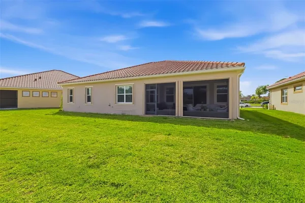 a view of a house with a backyard