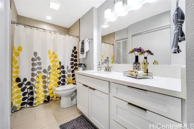 a bathroom with a sink mirror vanity and toilet