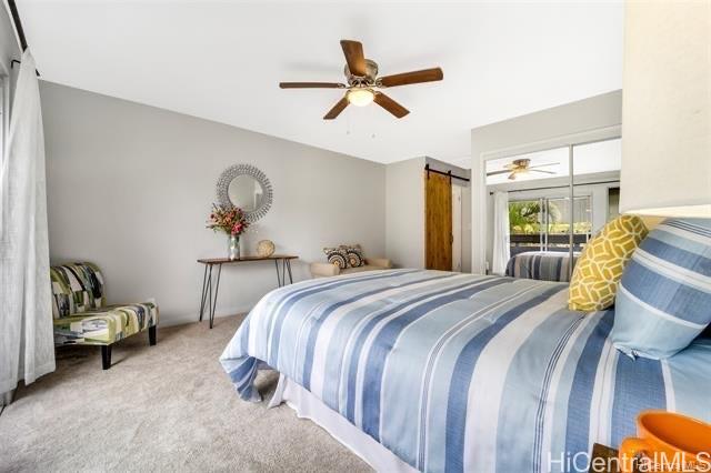 47-261 Hui Iwa Street, Unit 64 Kaneohe, HI 96744 - Photo 15 of 21 a bedroom with a bed and ceiling fan