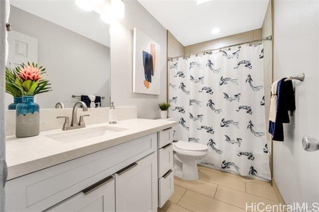 47-261 Hui Iwa Street, Unit 64 Kaneohe, HI 96744 - Photo 16 of 21 a bathroom with a sink toilet and shower