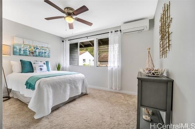 47-261 Hui Iwa Street, Unit 64 Kaneohe, HI 96744 - Photo 18 of 21 a bedroom with a bed and a chandelier