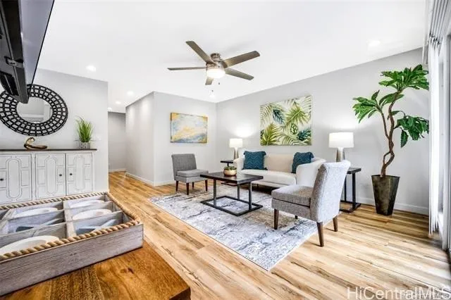 a living room with furniture and a wooden floor