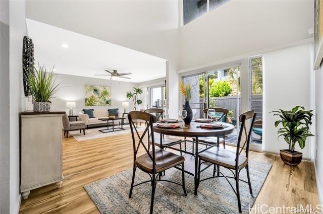 47-261 Hui Iwa Street, Unit 64 Kaneohe, HI 96744 - Photo 5 of 21 a dining room with furniture a floor to ceiling window and potted plants