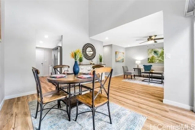 a view of a dining room and kitchen with a table chairs