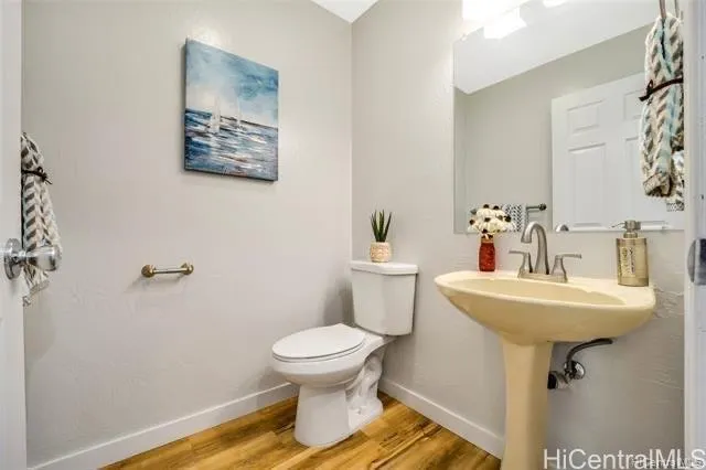 a bathroom with a sink toilet and a mirror
