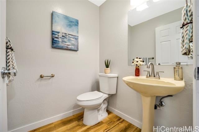47-261 Hui Iwa Street, Unit 64 Kaneohe, HI 96744 - Photo 10 of 21 a bathroom with a sink toilet and a mirror