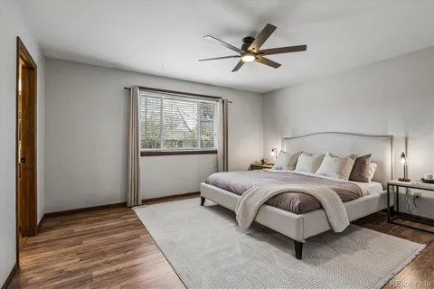 a spacious bedroom with a large bed and a chandelier
