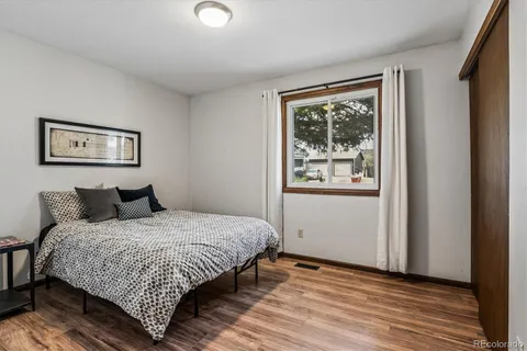a bedroom with a large bed and a window