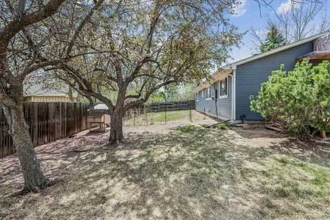 a view of a house with a yard and tree