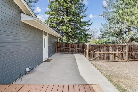 a view of balcony with wooden floor and fence