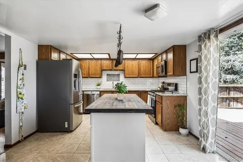 a kitchen with refrigerator and cabinets
