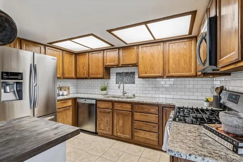 a kitchen with stainless steel appliances a stove sink and cabinets