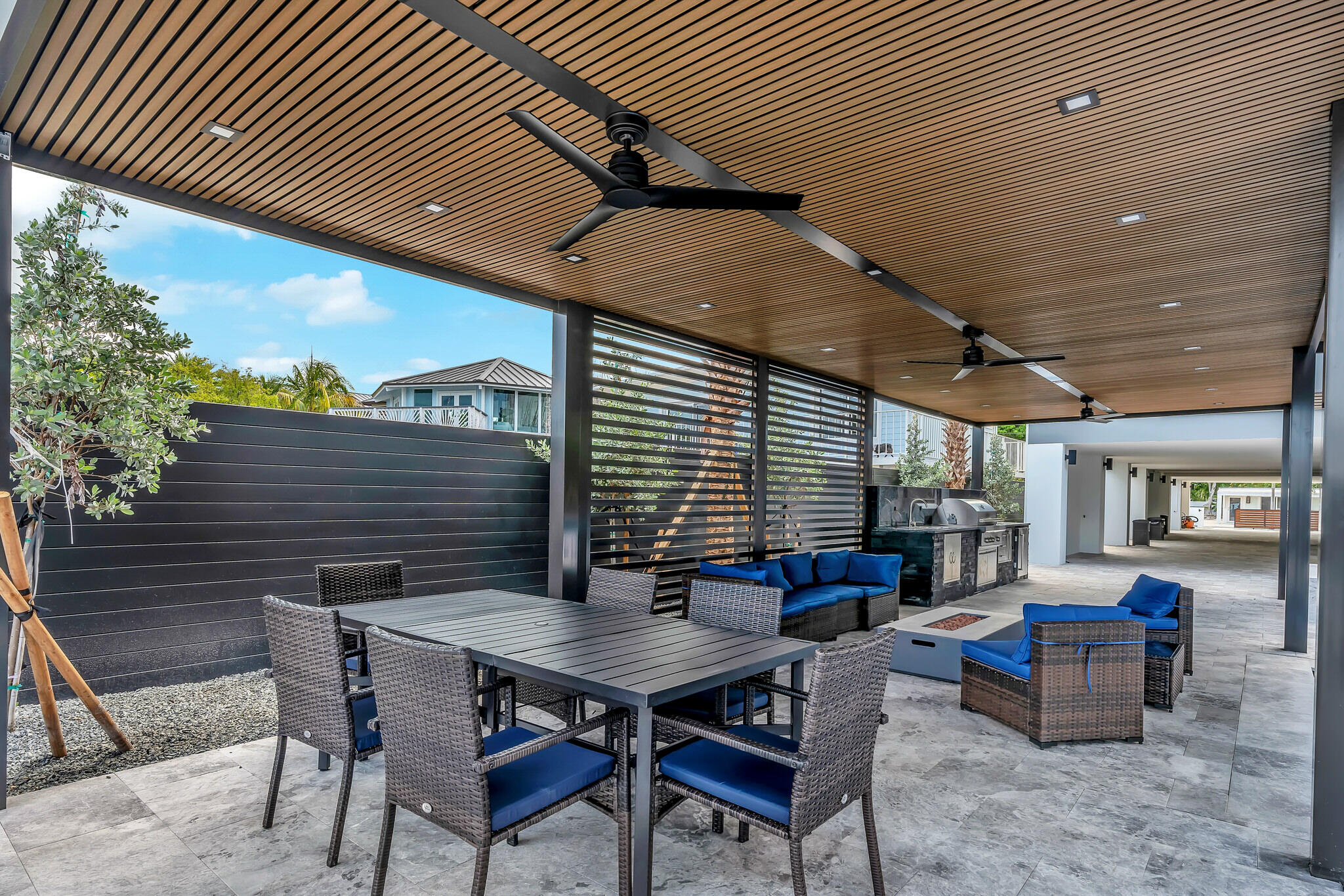 16 Seaside Avenue Key Largo, FL 33037 - Photo 122 of 140 a backyard of a house with dining table and chairs with plants