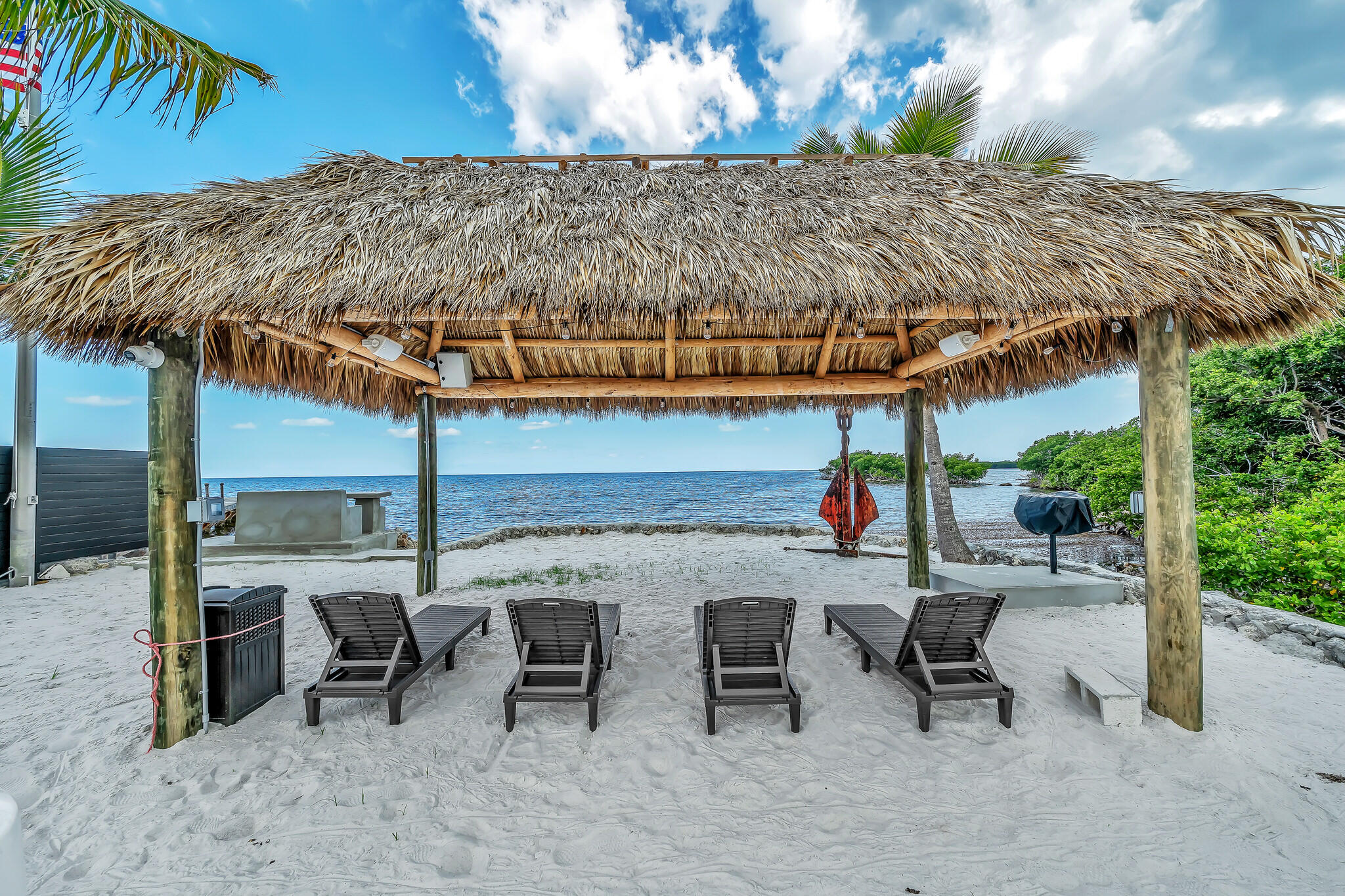 16 Seaside Avenue Key Largo, FL 33037 - Photo 127 of 140 a view of a patio with table and chairs under an umbrella