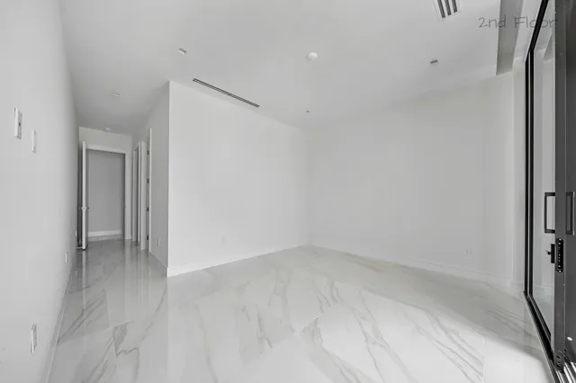 a view of hallway with wooden floor