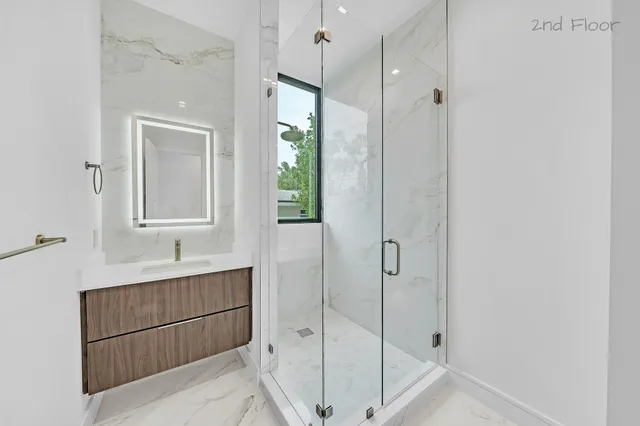 a bathroom with a glass shower door