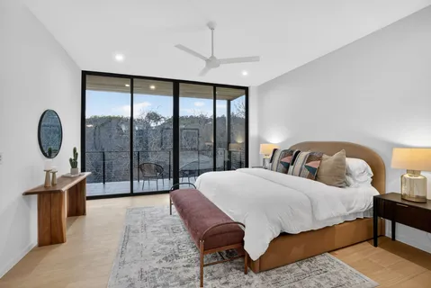 a bedroom with a large bed and a large window