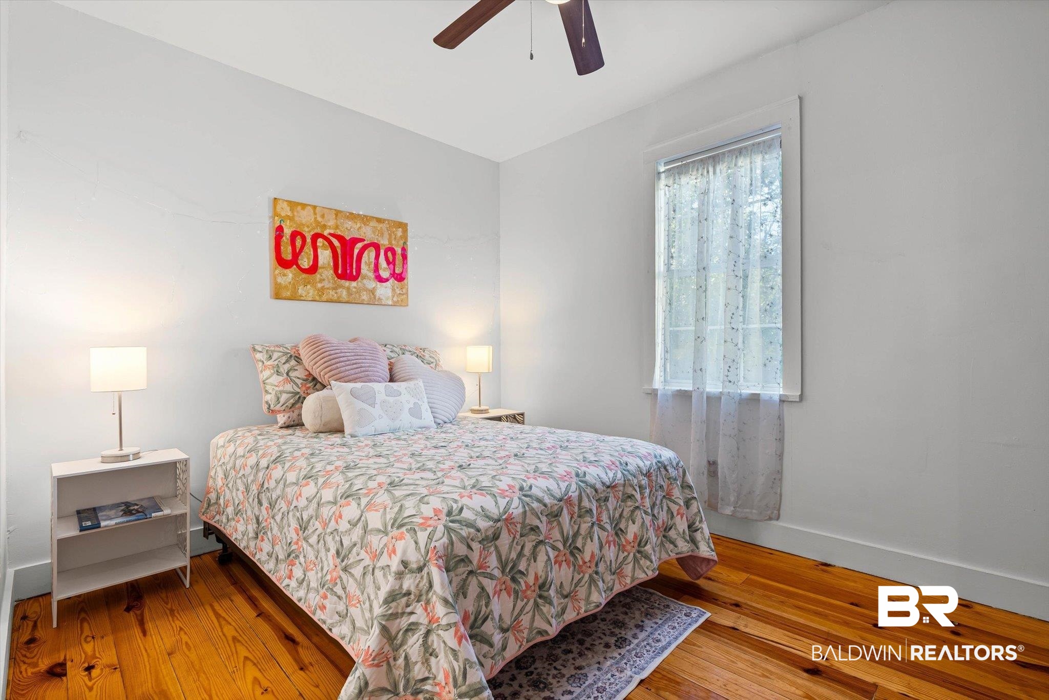 951 Montgomery Street Mobile, AL 36604 - Photo 11 of 22 Room featuring a window with sheer coverings, light-toned walls, and wood-finish flooring