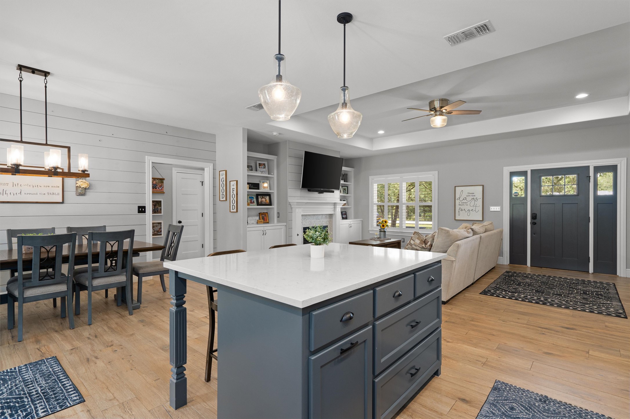 136 Fawn Hollow Elgin, TX 78621 - Photo 11 of 40 Open concept living area featuring wood-finish flooring, a kitchen island with a light-toned countertop, and recessed lighting