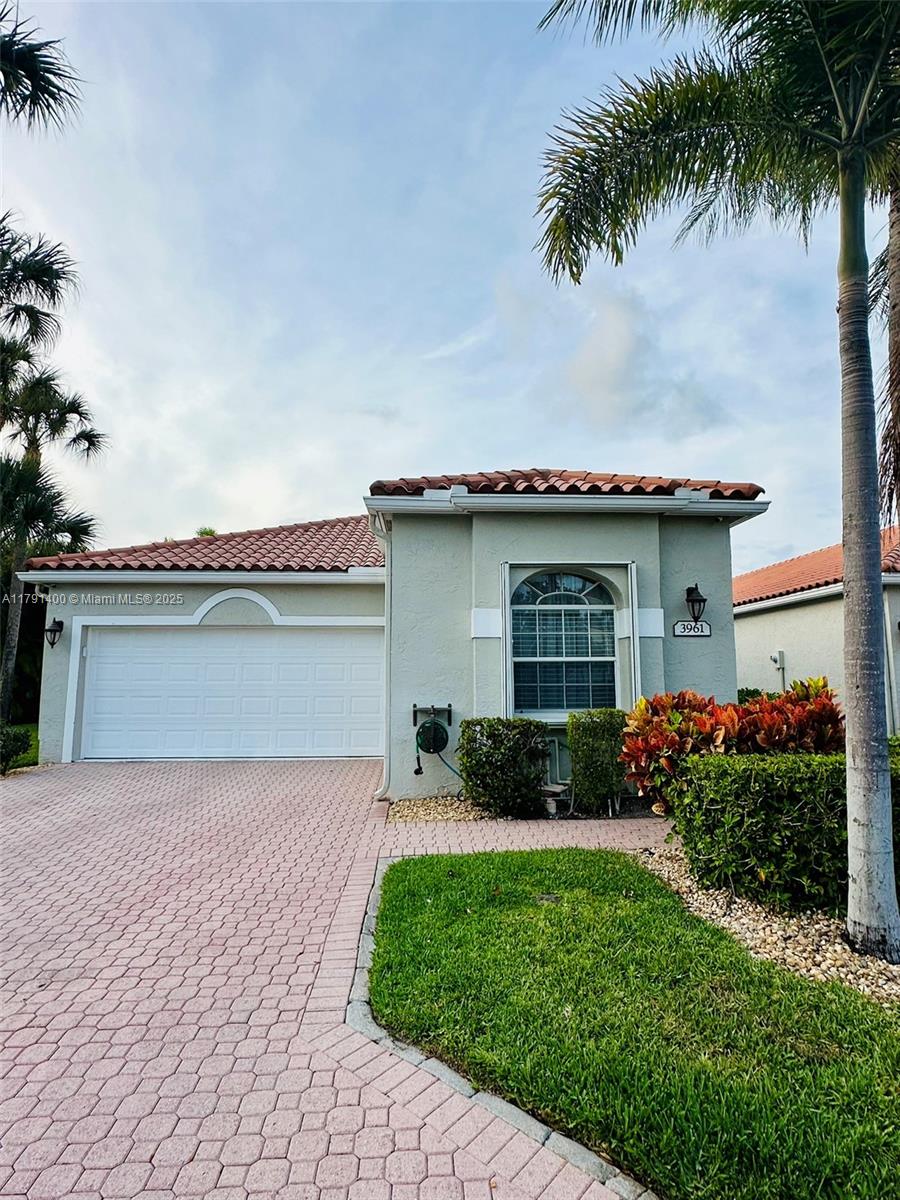 3961 Antigua Point Drive Boca Raton, FL 33487 - Photo 1 of 65 a front view of a house with garden