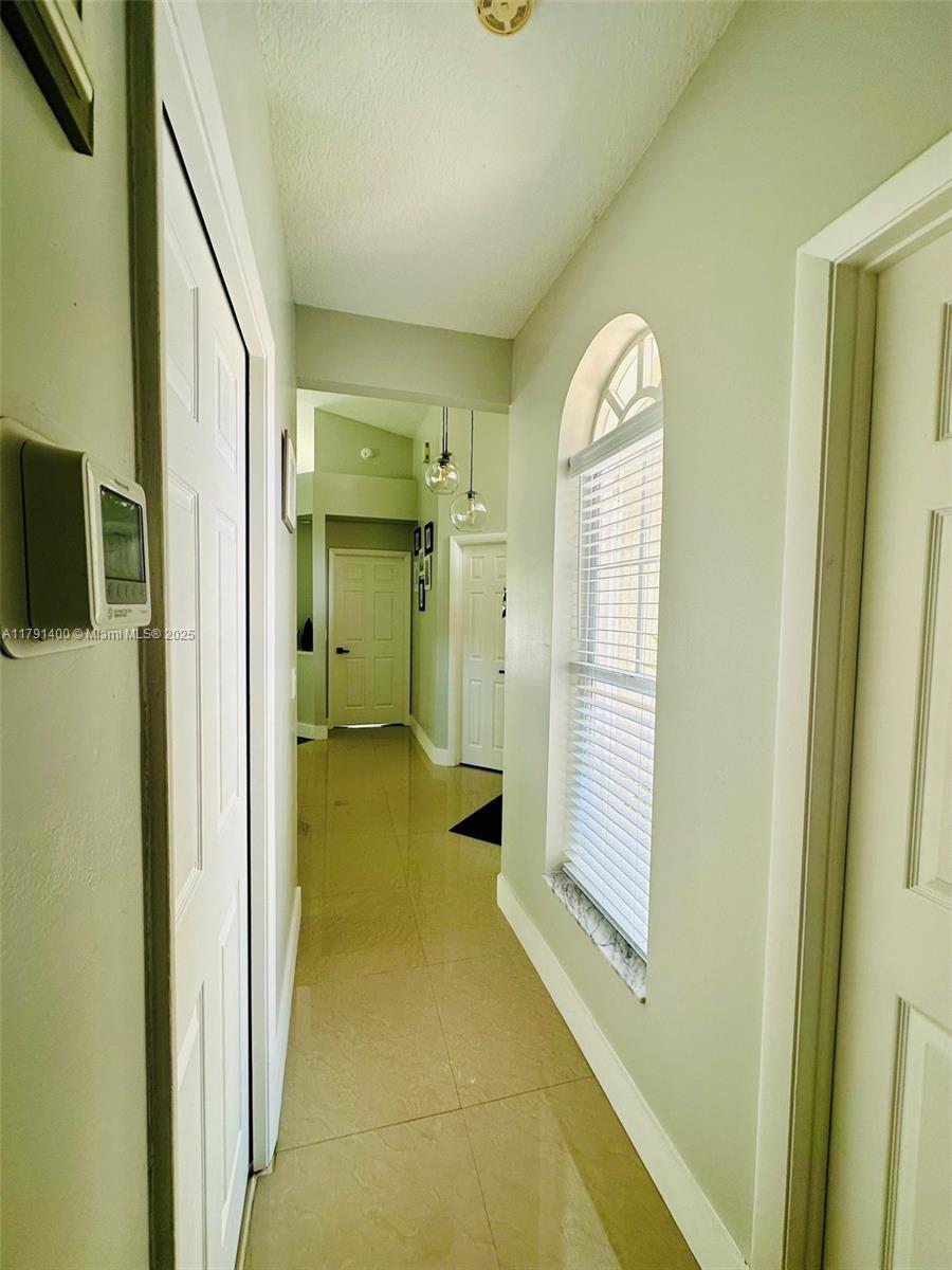 3961 Antigua Point Drive Boca Raton, FL 33487 - Photo 12 of 65 a view of a hallway with wooden floor and glass door