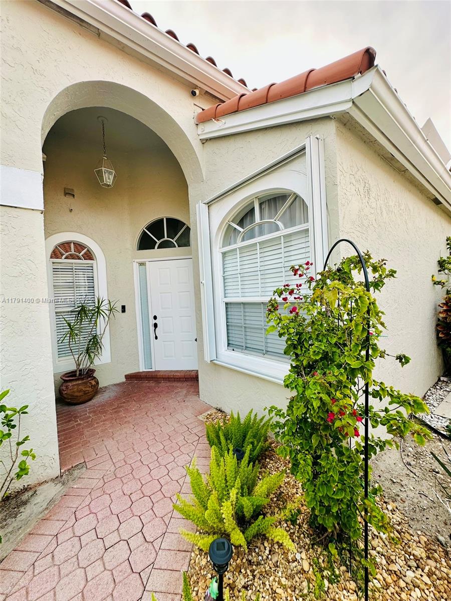 3961 Antigua Point Drive Boca Raton, FL 33487 - Photo 2 of 65 a front view of a house with potted plants